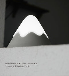 Touch-activated mountain night light on dresser