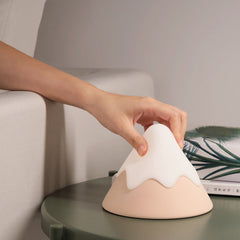 Touch-activated mountain night light on dresser