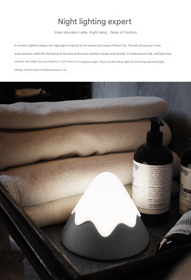 Rechargeable LED mountain lamp on bedside table