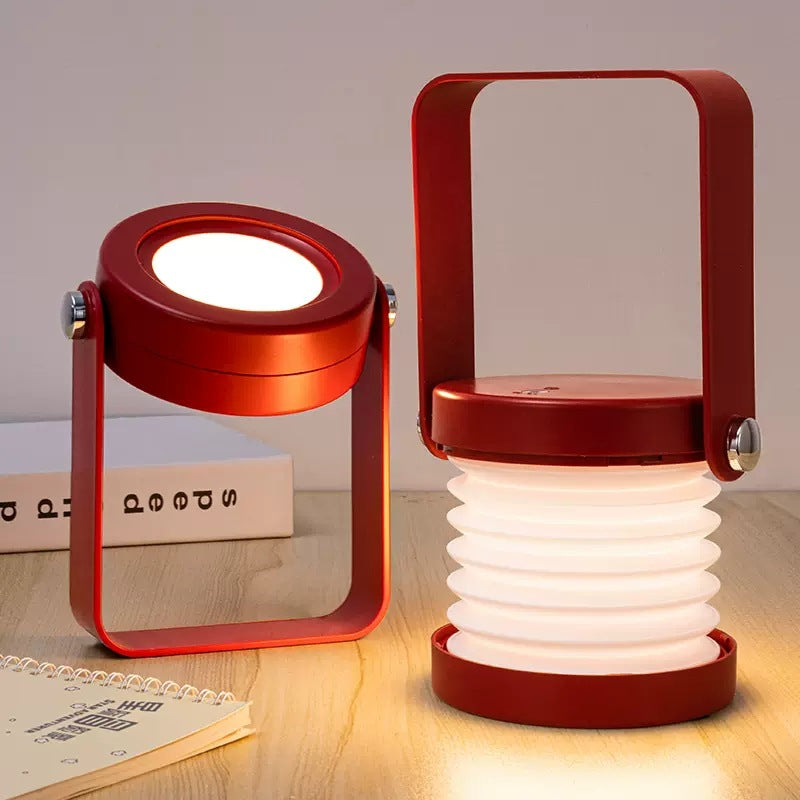 Folding LED lantern next to books on a desk