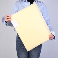 Person carrying A3 art folder outdoors
