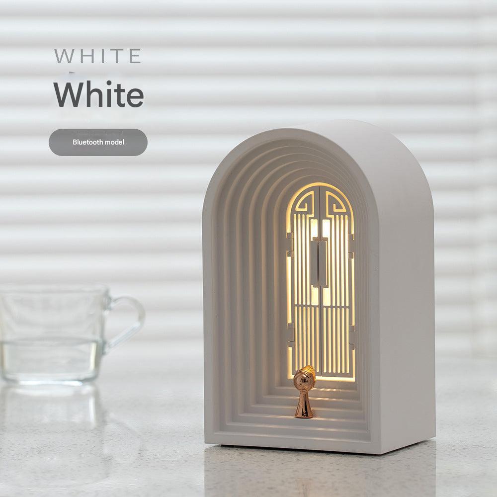 Bluetooth lamp next to books on a desk