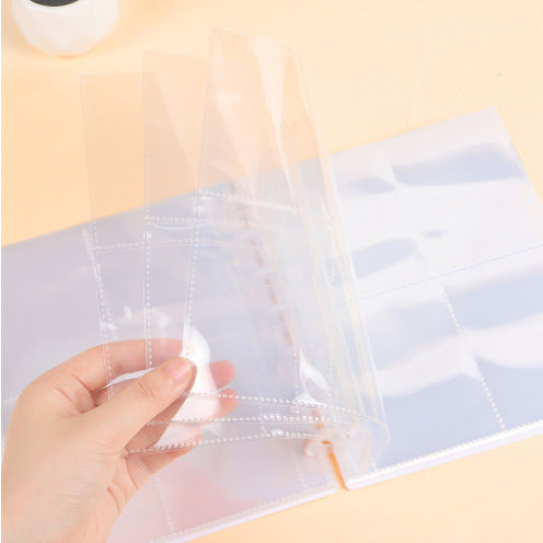 Open A4 photo album showing card slots in four-grid layout