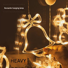 Fairy lights in window showing festive shapes