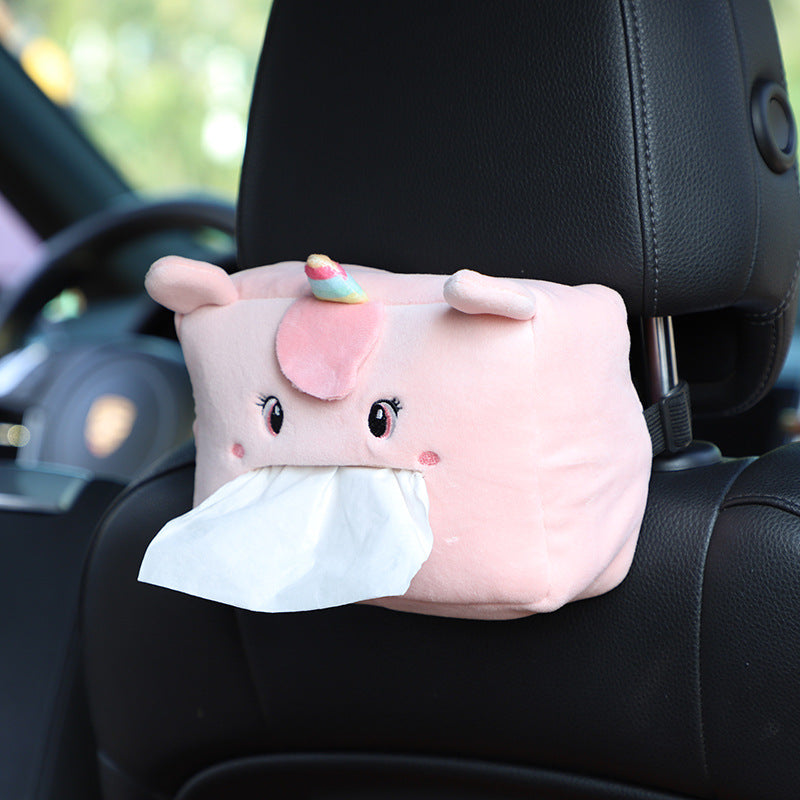 Plush lion tissue box dispenser in car interior