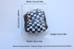 Detailed look at black and white checkered pattern steering wheel cover