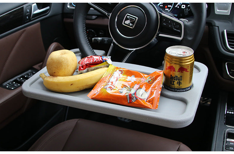 Steering wheel desk holding tablet and food