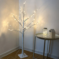 Illuminated LED birch tree light in night setting