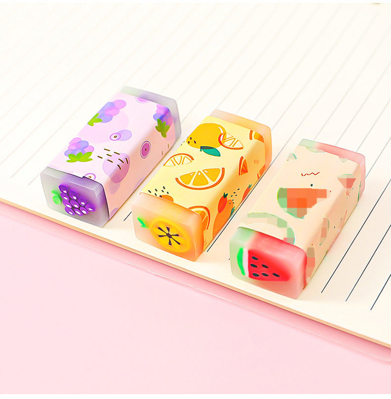 brightly coloured fruit erasers arranged