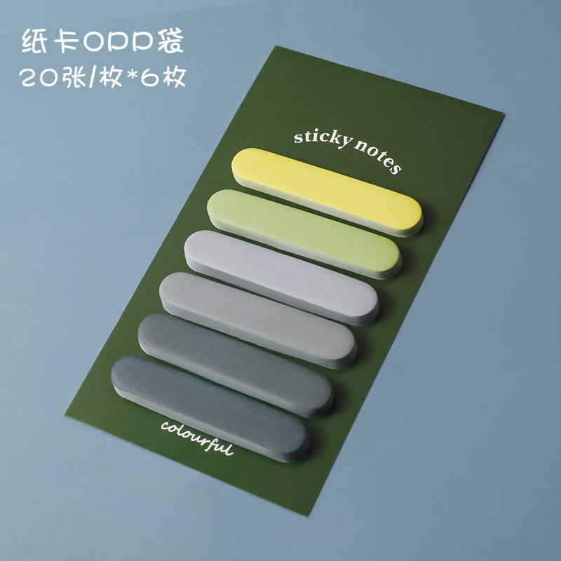yellow gradient sticky notes scattered on a notebook