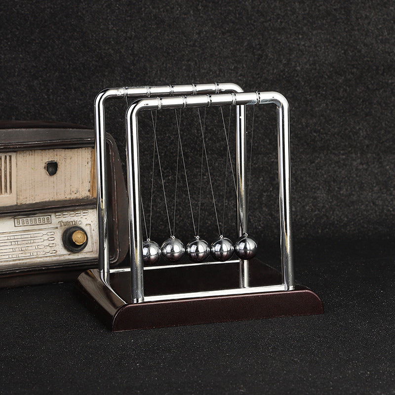 Close-up of black base Newton's Cradle in action
