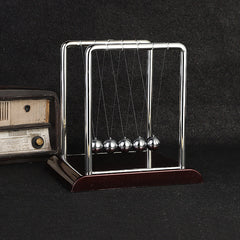 Detail of Newton's Cradle balls in mid-swing