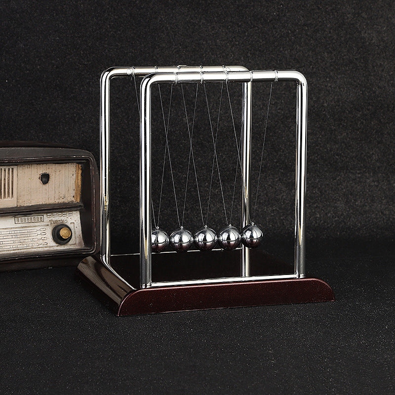 Detail of Newton's Cradle balls in mid-swing