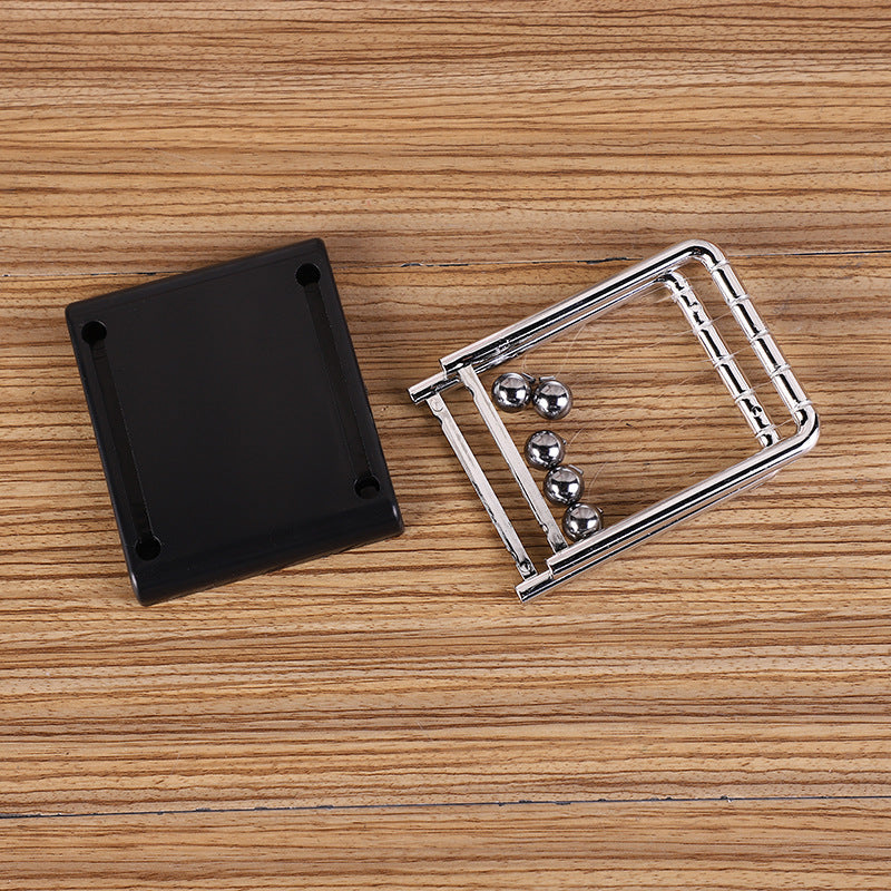 Newton's Cradle desk toy showcasing motion
