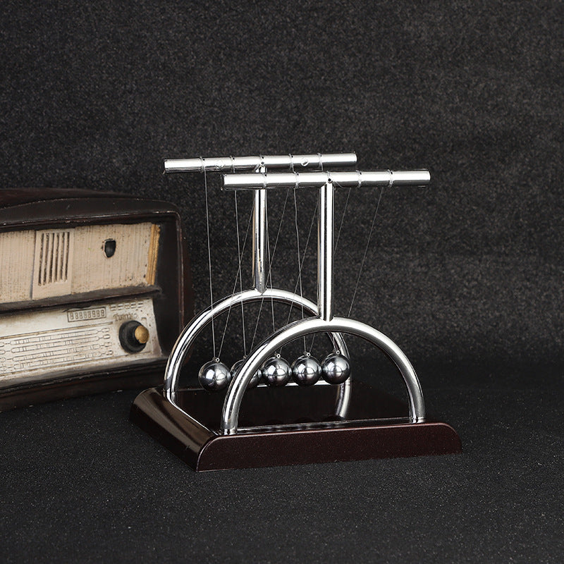 Close-up of black base Newton's Cradle in action