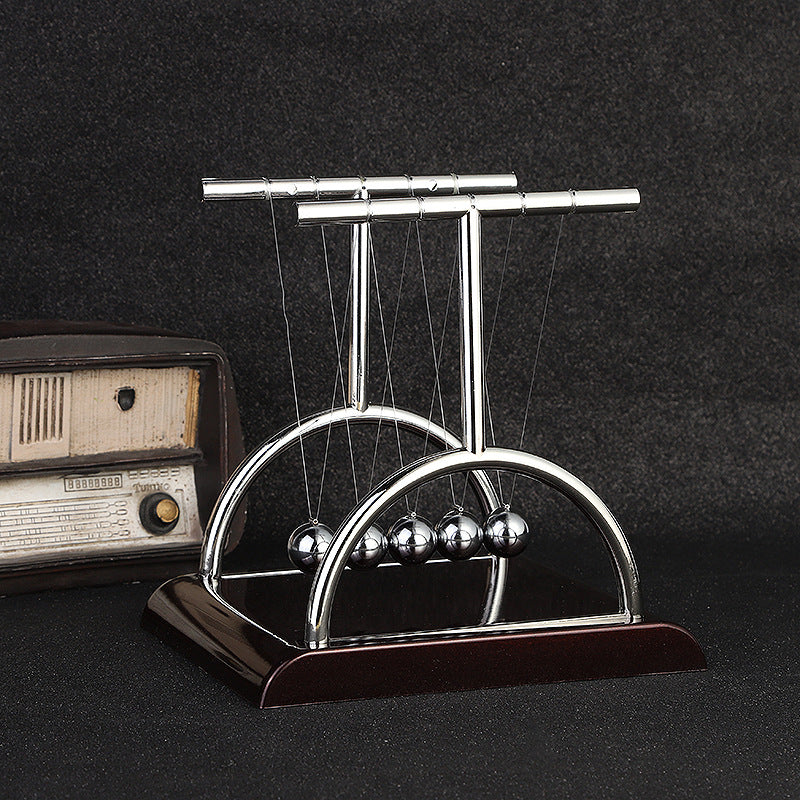 Detail of Newton's Cradle balls in mid-swing