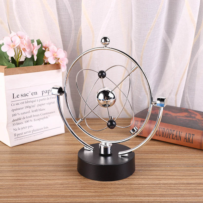 close up of swinging sticks on Newton Pendulum