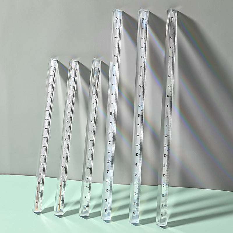 student using acrylic triangular ruler on desk
