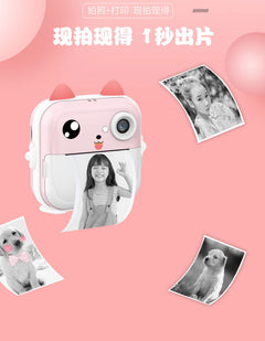 child examining photo from pink instant camera