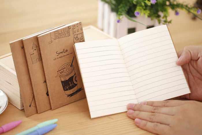 person writing in a vintage kraft notebook