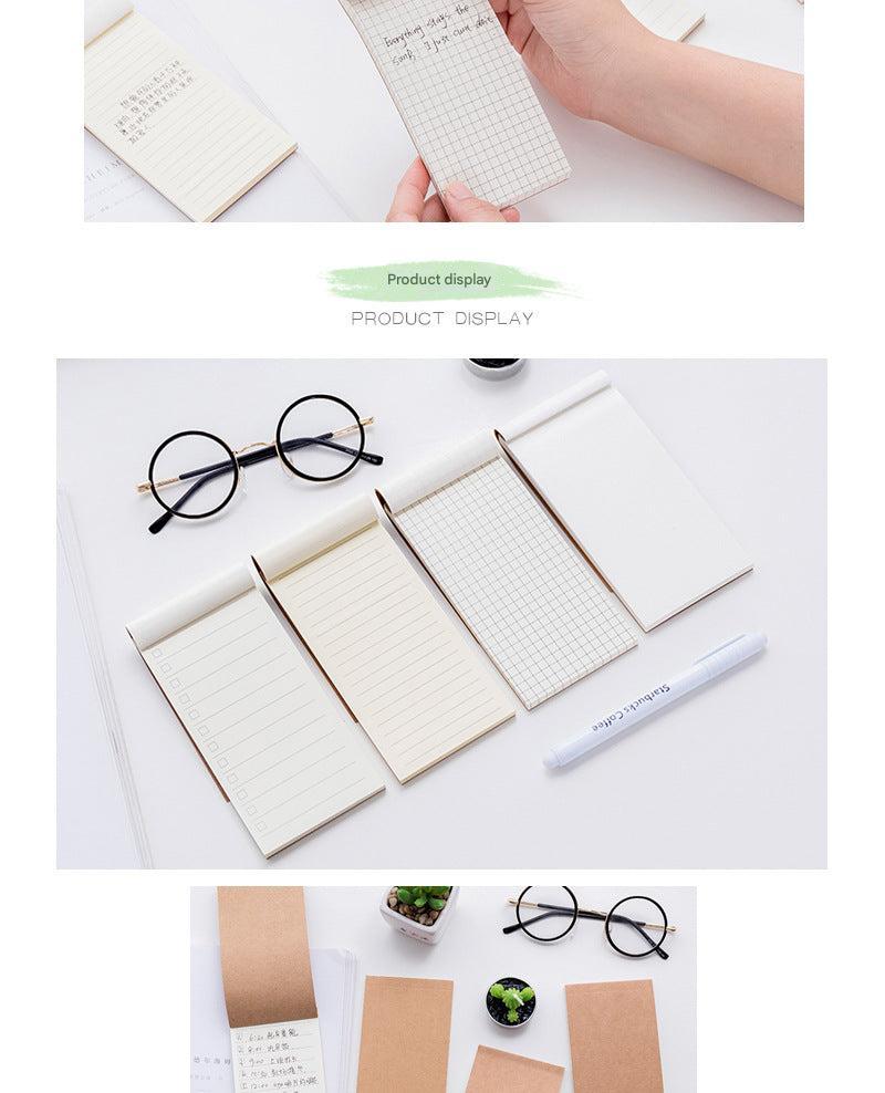 notepad on wooden desk with coffee mug