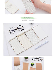 notepad on wooden desk with coffee mug