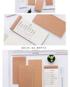 notepad placed next to computer in office setting