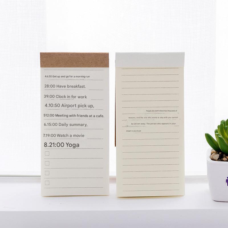 notepad on wooden desk with coffee mug