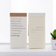 notepad on wooden desk with coffee mug