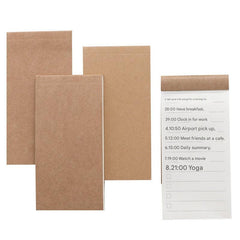 notepad placed next to computer in office setting
