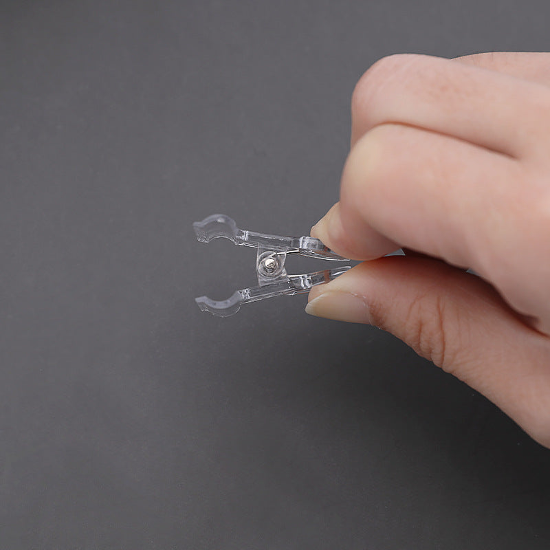 Clear tail clip securing papers