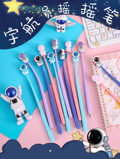 Set of astronaut-themed gel pens on a white background