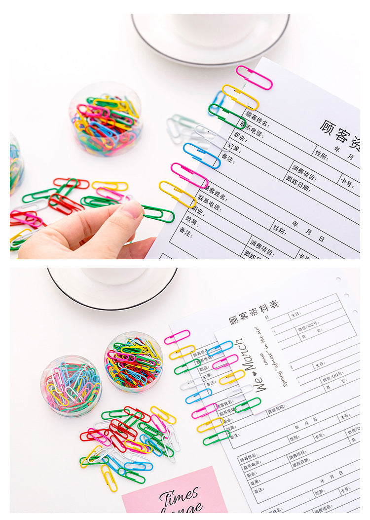 Box of multicoloured curved paper clips