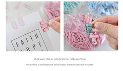 Mixed coloured binder clips on a table