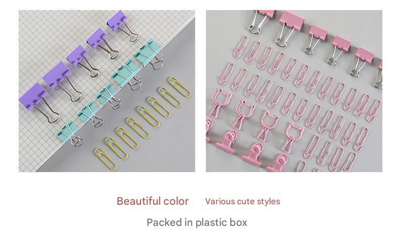 Assorted sizes of metal binder clips on a desk