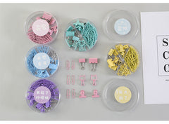 Metal binder clips in various colours arranged