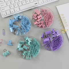 Assorted sizes of metal binder clips on a desk