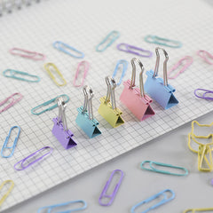Close-up of vibrant pink and blue binder clips