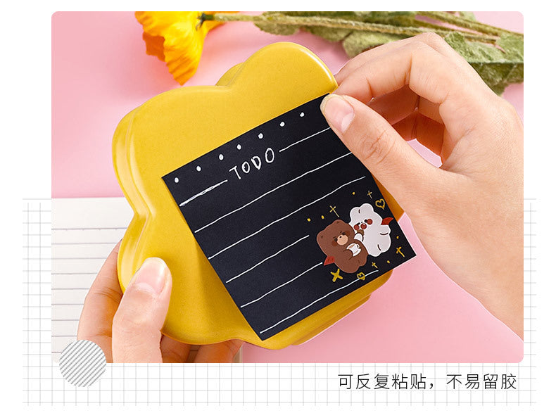 Close-up of black memo pad with writing