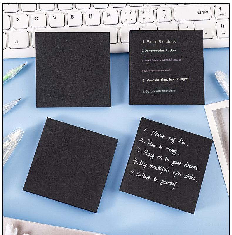 Student using black sticky notes in class