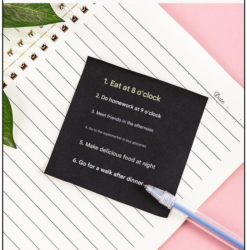 Compact black sticky notes displayed