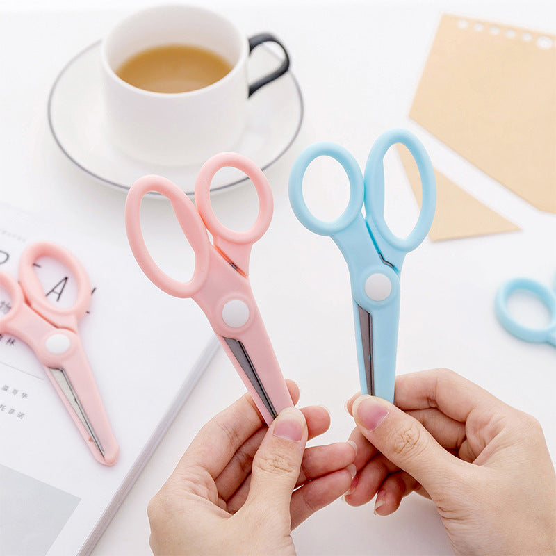 Child using ergonomic blue scissors