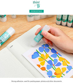 user applying solid glue stick to paper