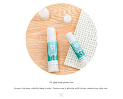 child using solid glue stick on craft project