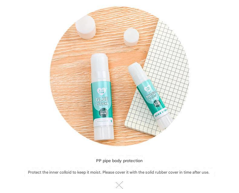 child using solid glue stick on craft project