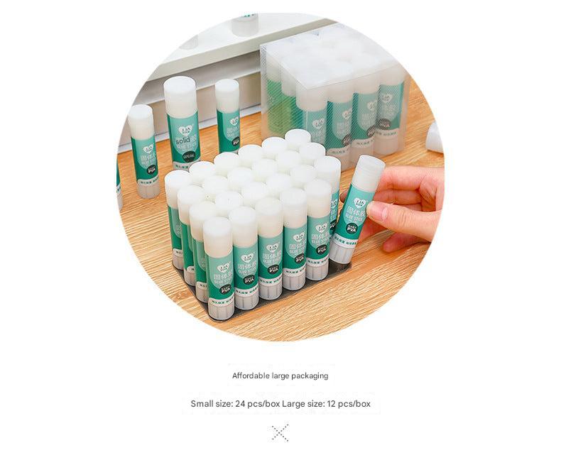 hand holding transparent solid glue stick