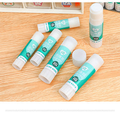 opened solid glue stick next to cap