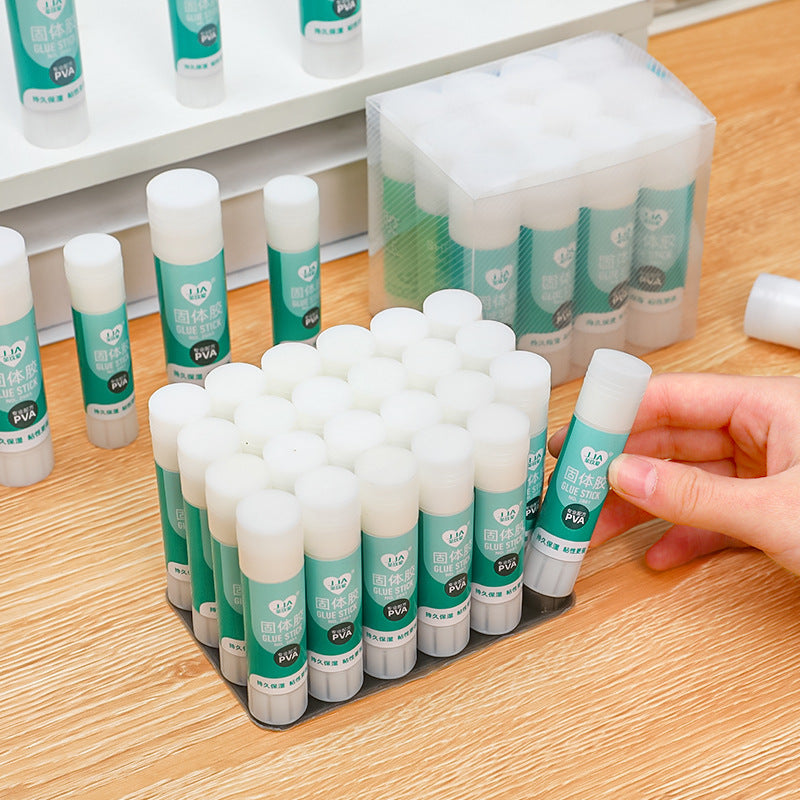 hand holding transparent solid glue stick