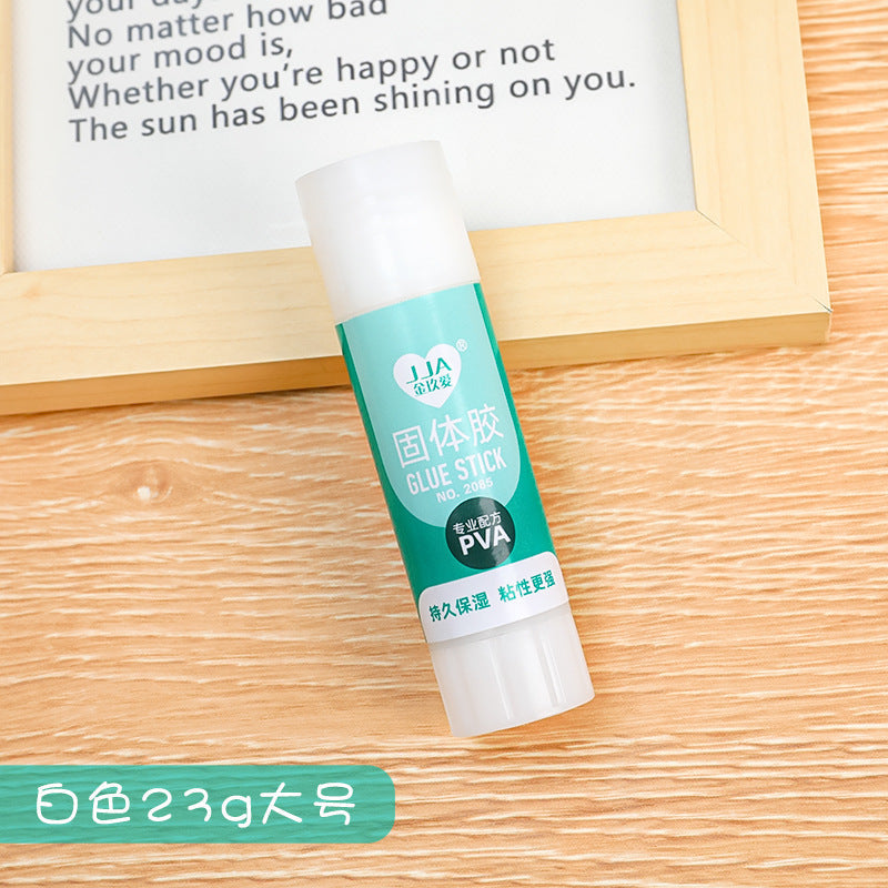 solid glue stick in-use sticking two papers