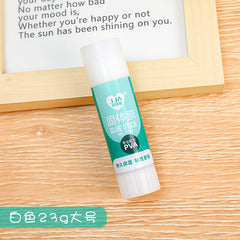 solid glue stick in-use sticking two papers